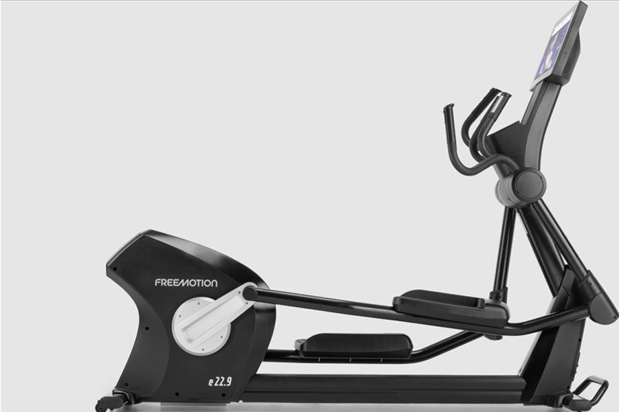 Freemotion e22.9 black and gray elliptical machine with digital console and extended stride, on white background