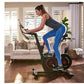 Woman on stationary exercise bike with black frame and red accents in home living room setting