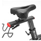 Black stationary exercise bike with padded seat, digital display console, and red rear tail light on white background
