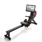 Echelon Row-s black connected rowing machine with red accents, tablet display mount, and digital resistance, shown from side 