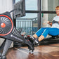 Echelon Row-s connected rowing machine with red accents, large fan wheel, and digital display, shown with woman exercising in