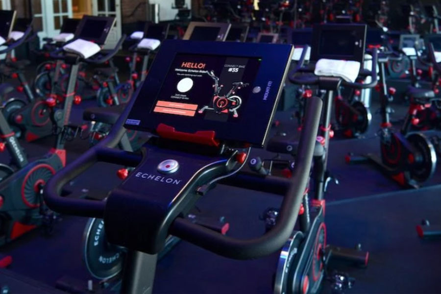 Echelon Connect Bike EX-3 stationary exercise bike with dark blue frame, red accents, and digital display screen in showroom 