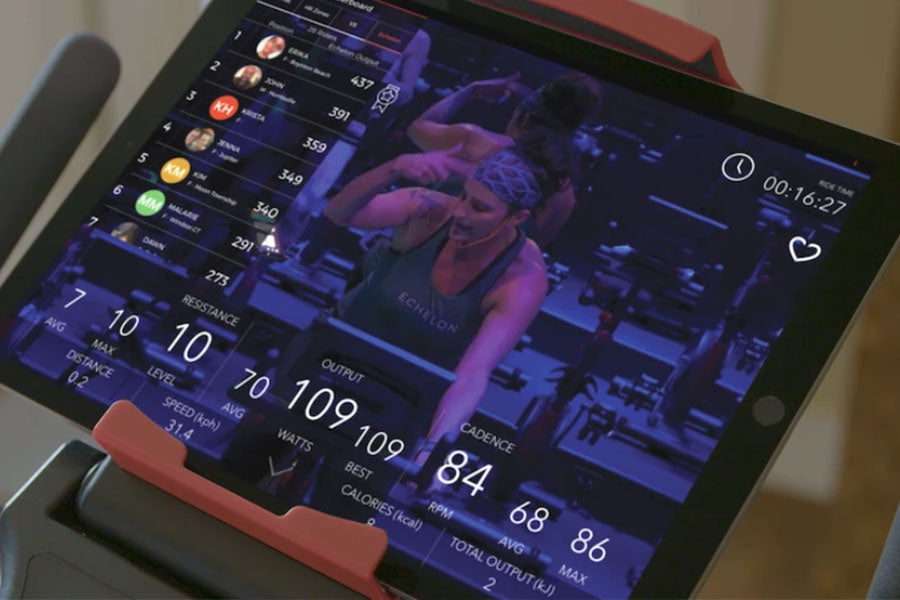 Echelon Connect Bike EX-3 tablet displaying indoor cycling workout metrics and instructor on screen