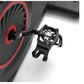 Black platform pedal with mesh straps attached to red and black exercise bike wheel, detail view