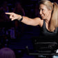 Woman wearing black striped racerback tank top on Echelon Smart Connect Bike EX-5s-10 in indoor cycling class setting