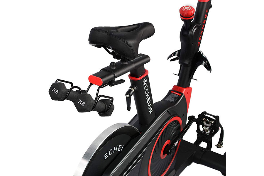 Black and red Echelon Connect stationary exercise bike with padded seat, red accents, digital display, and pair of black dumb