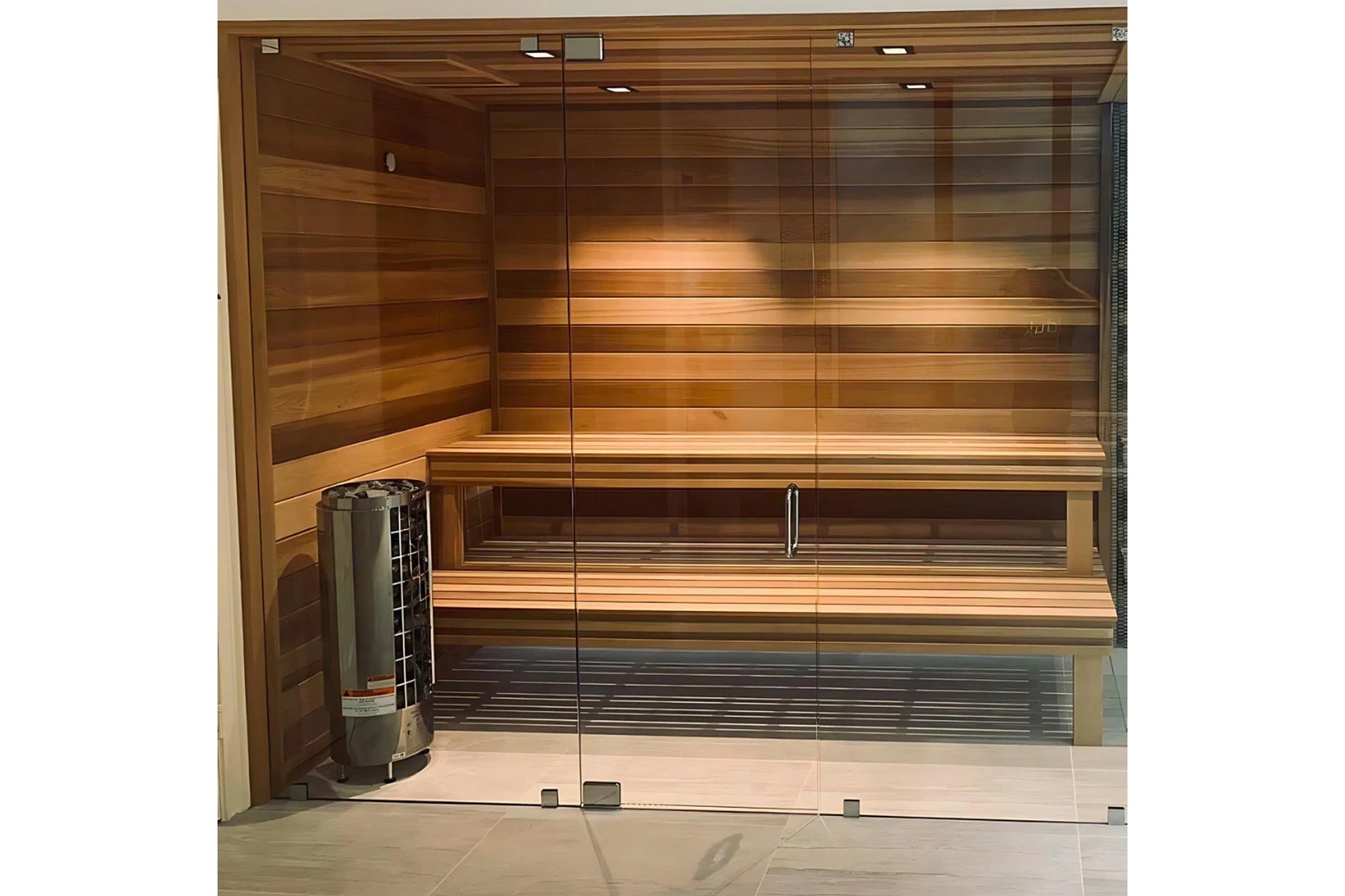 Harvia Cilindro cylindrical electric sauna heater with built-in dial controls, displayed in wooden sauna room with glass door