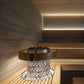 Harvia Cilindro electric sauna heater with white perforated steel body, brown leather belt band, and built-in controls on woo