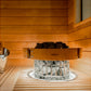 Harvia Cilindro electric sauna heater with wooden rim and metal basket filled with stones, positioned in wooden sauna interio