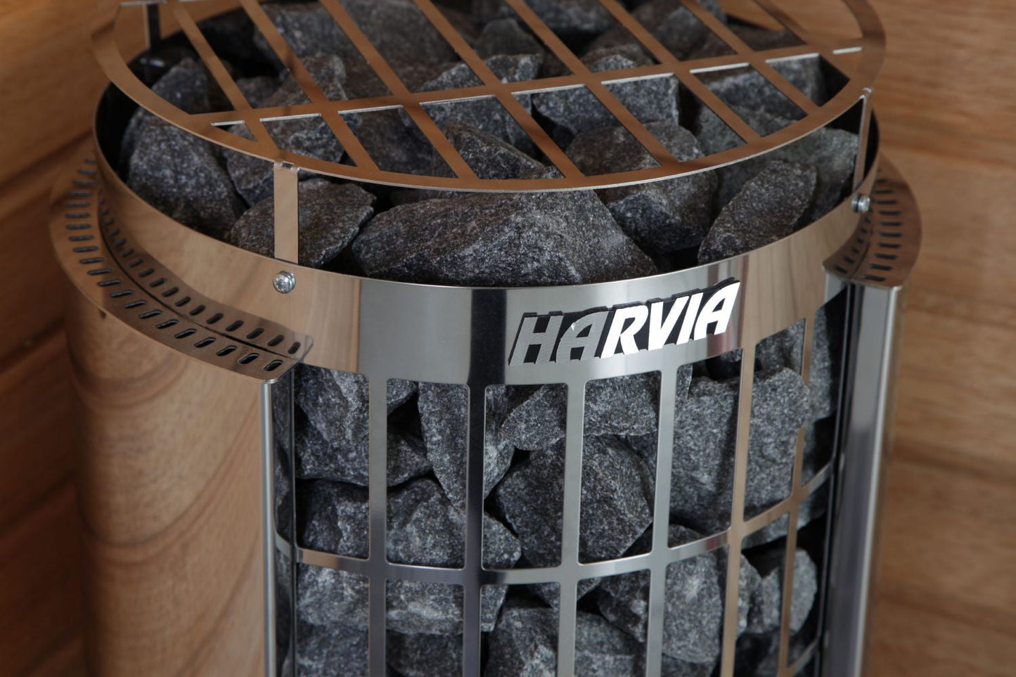 Harvia Cilindro electric sauna heater with stainless steel cage, filled with dark gray sauna stones and latticed top grate
