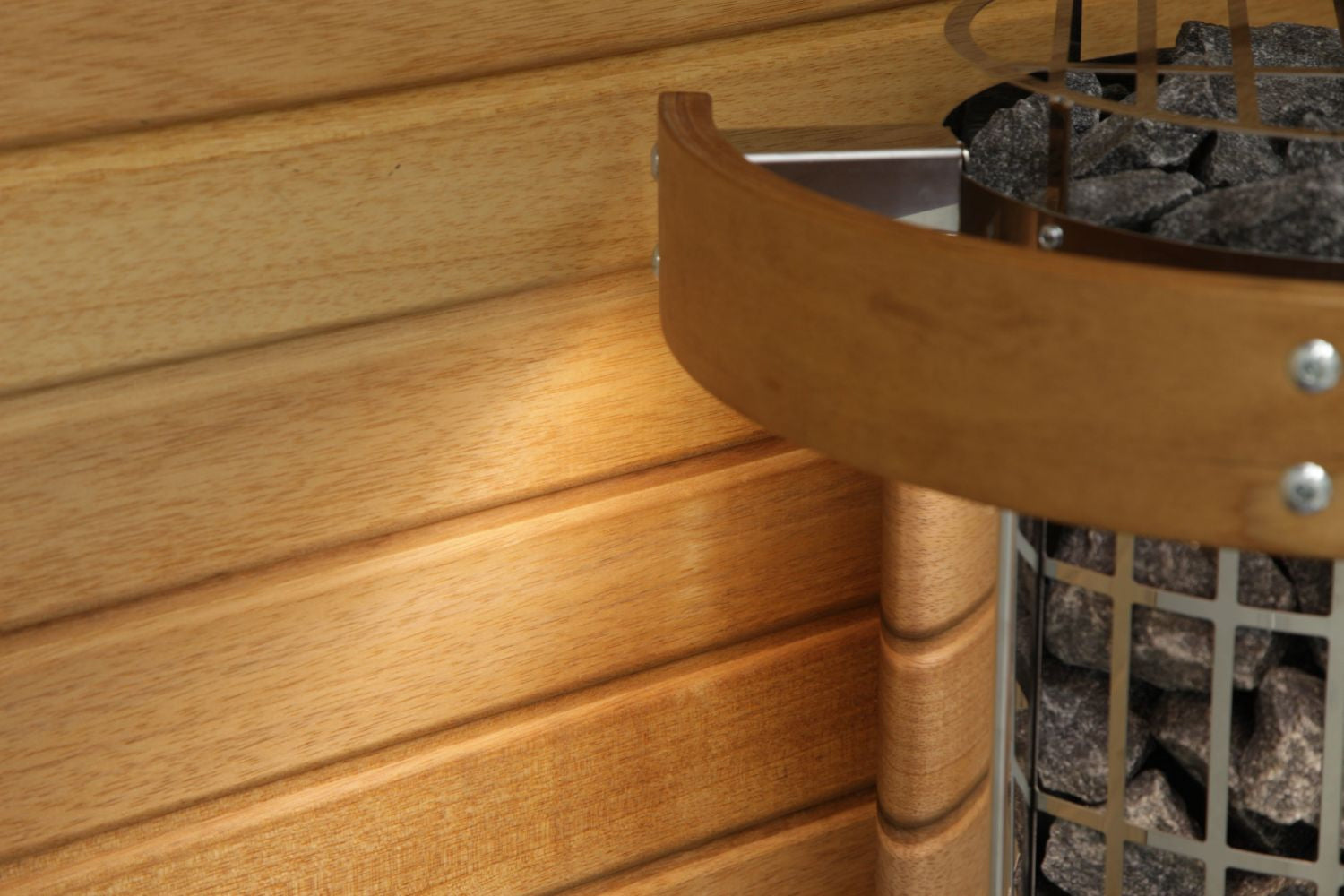Tan leather sauna bucket with stainless steel handle and metal rivets, positioned on wooden sauna bench