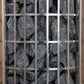 Harvia Cilindro electric sauna heater with stainless steel grid panel covering dark gray stones inside cylindrical chamber