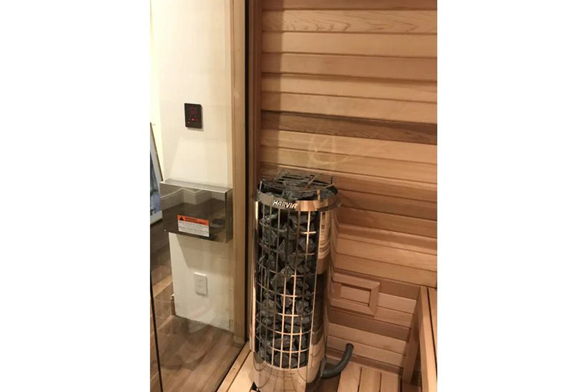 Harvia Cilindro cylindrical electric sauna heater with metal cage guard in wooden sauna room