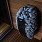 Harvia Spirit electric sauna heater with gray stones in metal basket on wooden deck