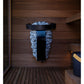 Harvia Spirit electric sauna heater with black metal top and blue stones, mounted on wooden sauna wall