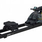 Black fluid rowing machine with digital display, black padded seat, and clear water resistance chamber on white background