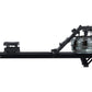 Black fluid rowing machine with transparent water tank on right side, footrest on left, displayed on white background