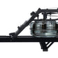 Black fluid rowing machine with glass carafe reservoir and articulating arm, side view on white background