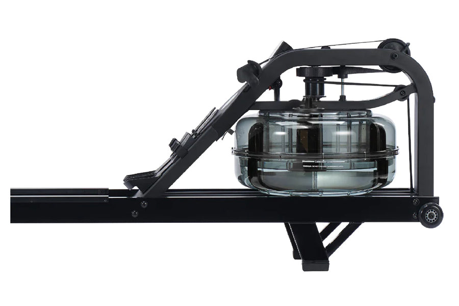 Black fluid rowing machine with glass carafe reservoir and articulating arm, side view on white background