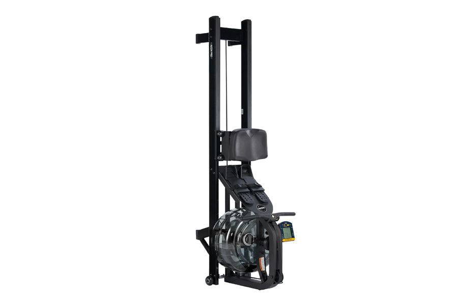 Black fluid rowing machine with tall frame, padded seat, and resistance wheel on white background