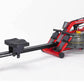 A red and black FluidRower Newport Challenge AR Rower with a black seat and a clear water tank in the center