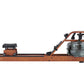Viking 3 Plus brown fluid rower with wooden frame, black seat, and water resistance tank, side view on white background