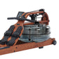 Brown wood frame rowing machine with black handle, digital monitor, and transparent water resistance tank on white background