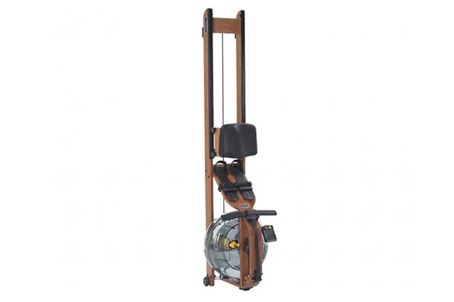 Wooden frame vertical rowing machine with dark padded seat, black footrest, and large circular water resistance chamber, disp