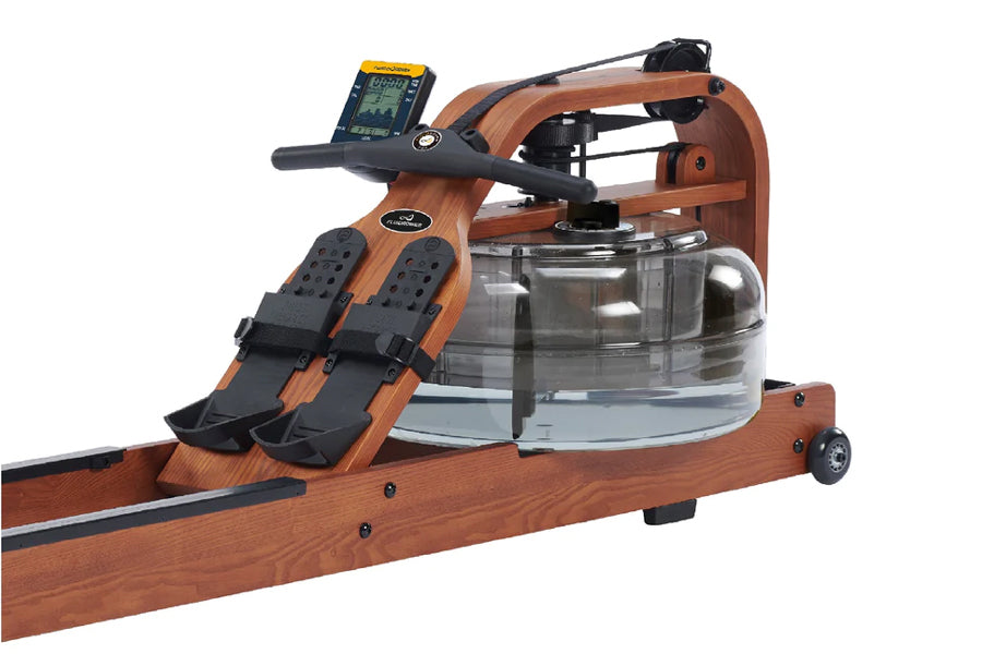 Wood-grain brown fluid rower with black digital monitor, footrests, and clear water resistance chamber on white background