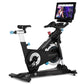 Black and blue stationary exercise bike with tablet display showing fitness class, on white background
