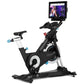 FreeMotion black and silver stationary exercise bike with blue accents, large flywheel, handlebar-mounted screen, and adjusta