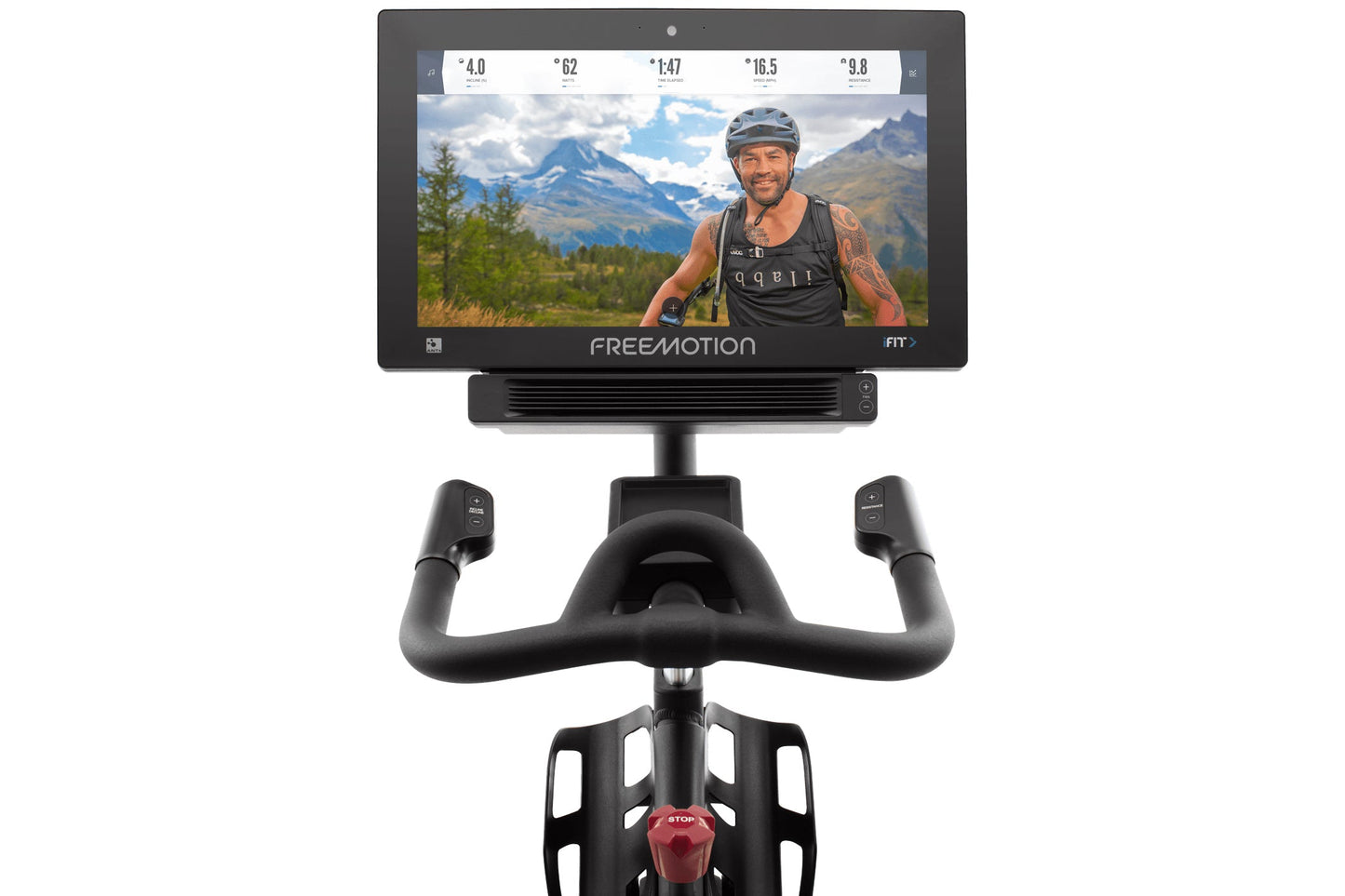 Black stationary bike with curved handlebars, red seat, and mounted display screen showing cyclist in mountain landscape on w
