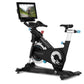 Black and white stationary exercise bike with blue accents, equipped with tablet display showing cycling video, on white back