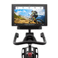 Freemotion CoachBike indoor exercise bike with black frame, curved handlebars, and mounted digital display screen showing mou