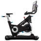 Freemotion CoachBike indoor exercise bike with black frame, blue accents, adjustable seat, handlebar, and mounted smartphone 