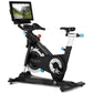 Black and white stationary exercise bike with blue accents, digital screen display mounted on articulating arm, flat pedals, 