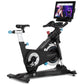 Black and silver Freemotion CoachBike stationary cycle with blue accent grips, attached touchscreen display showing video con