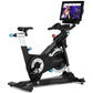 Freemotion CoachBike indoor exercise bike with black frame, blue accents, touchscreen display mounted on handlebar, and silve