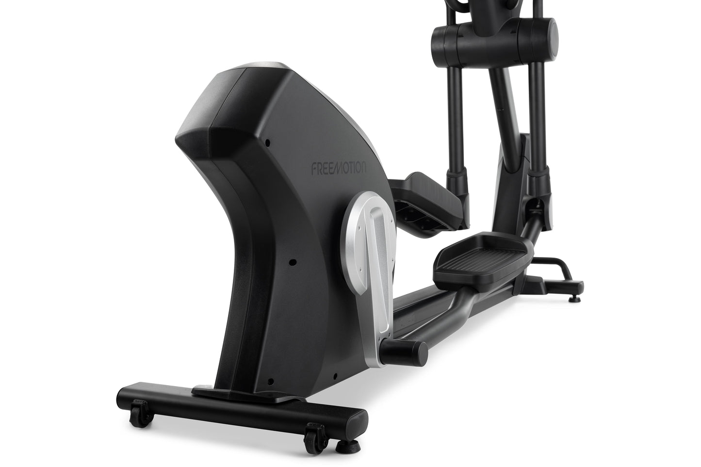 Black and silver Freemotion e10.9b elliptical machine with digital display and foot pedals on white background