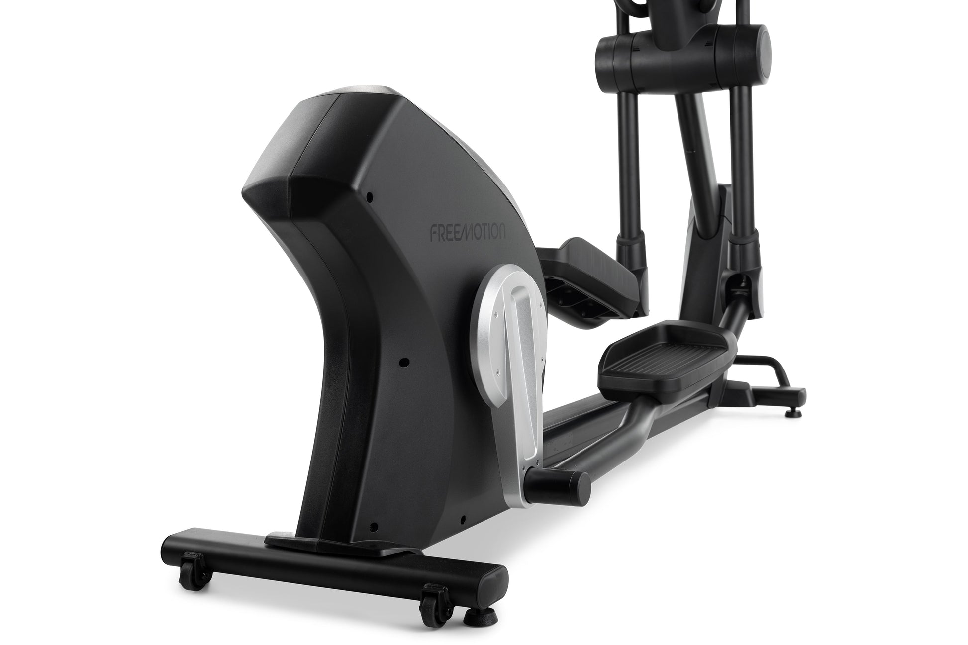 Black and silver Freemotion e10.9b elliptical machine with digital display and foot pedals on white background