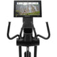 Black Freemotion elliptical with curved handles, digital display screen showing fitness metrics and video content, on white b
