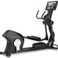 Black Freemotion e22.9 elliptical machine with digital touchscreen display, curved handlebars, and pedals on white background