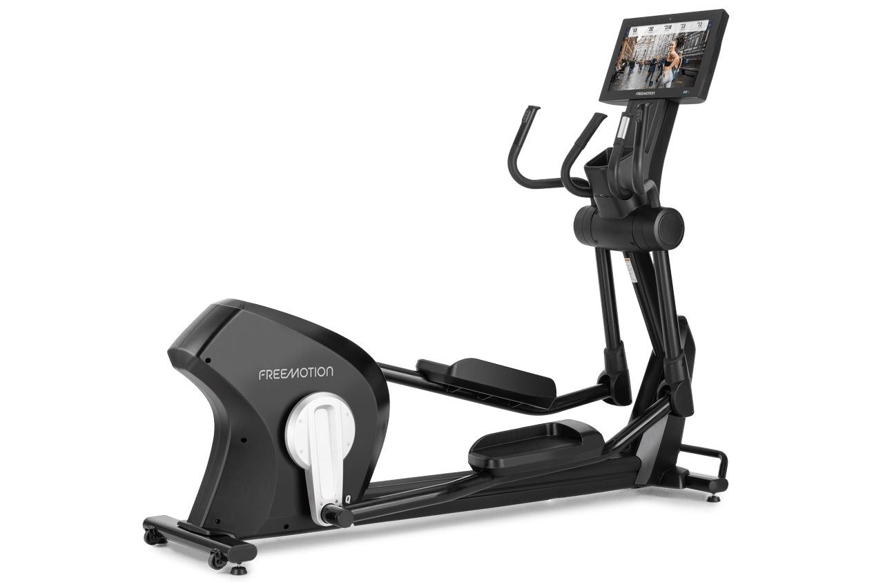 Black Freemotion e22.9 elliptical machine with digital touchscreen display, curved handlebars, and pedals on white background