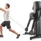 Man in white shirt and black shorts using black Freemotion dual cable cross machine with digital display, demonstrating cable