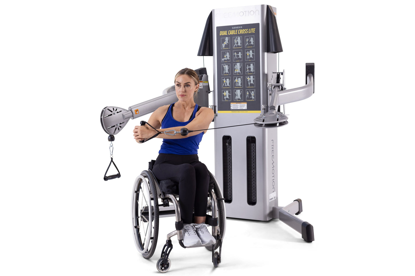 Woman in wheelchair using silver and black Freemotion dual cable cross machine with exercise diagram display, demonstrating u