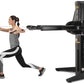 Woman performing chest fly exercise on black Freemotion Genesis G624 dual cable cross machine with adjustable arms