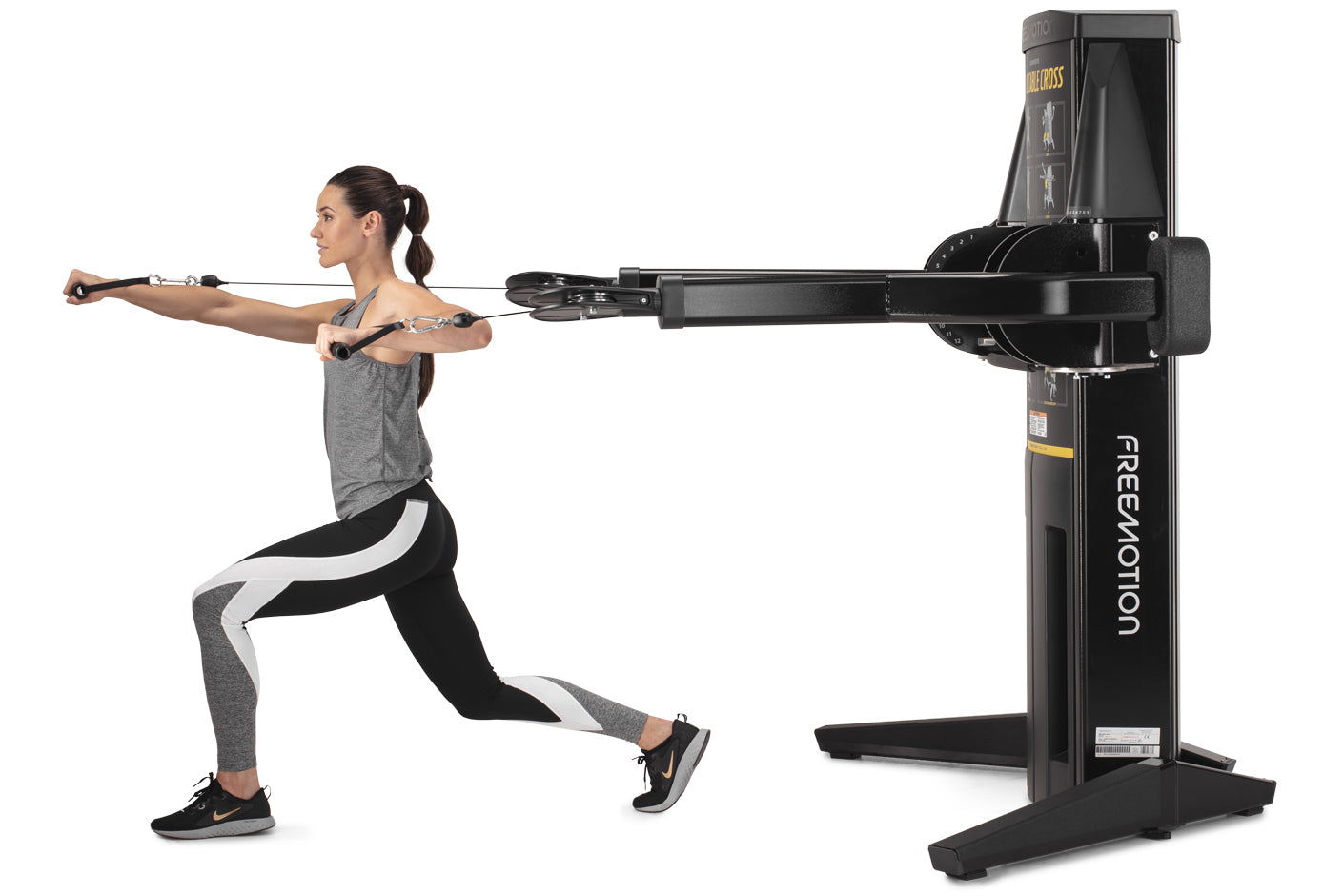 Woman performing chest fly exercise on black Freemotion Genesis G624 dual cable cross machine with adjustable arms