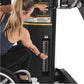 Woman using black dual cable crossover machine with weight stack, worn by model demonstrating exercise equipment