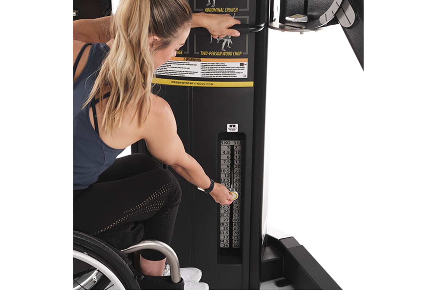 Woman using black dual cable crossover machine with weight stack, worn by model demonstrating exercise equipment