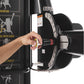 Hand adjusting black and red weight pin on Freemotion Genesis G624 dual cable cross machine with exercise instructions visibl